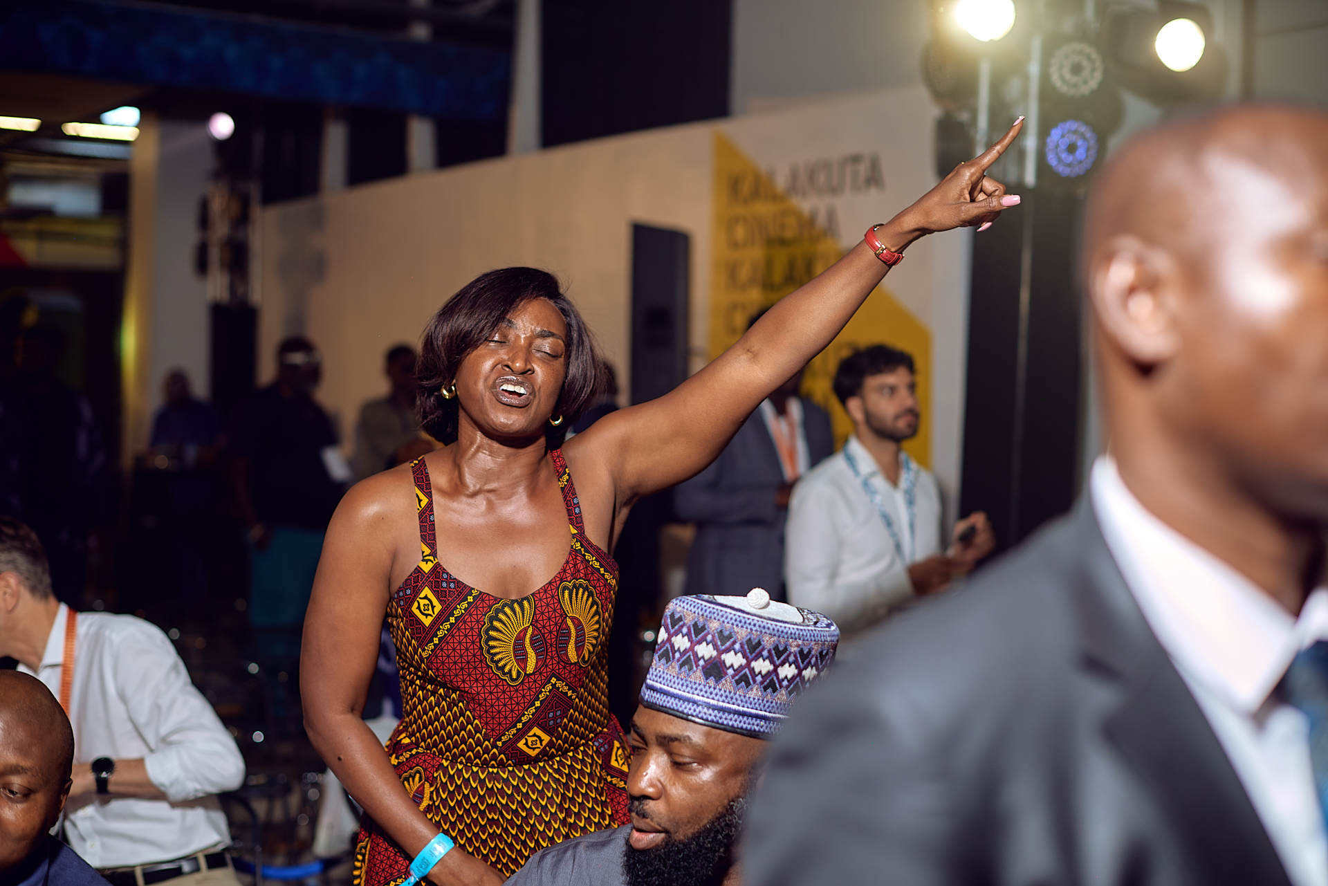 Guest dancing with arm raised beside the Kalakuta Cinema installation