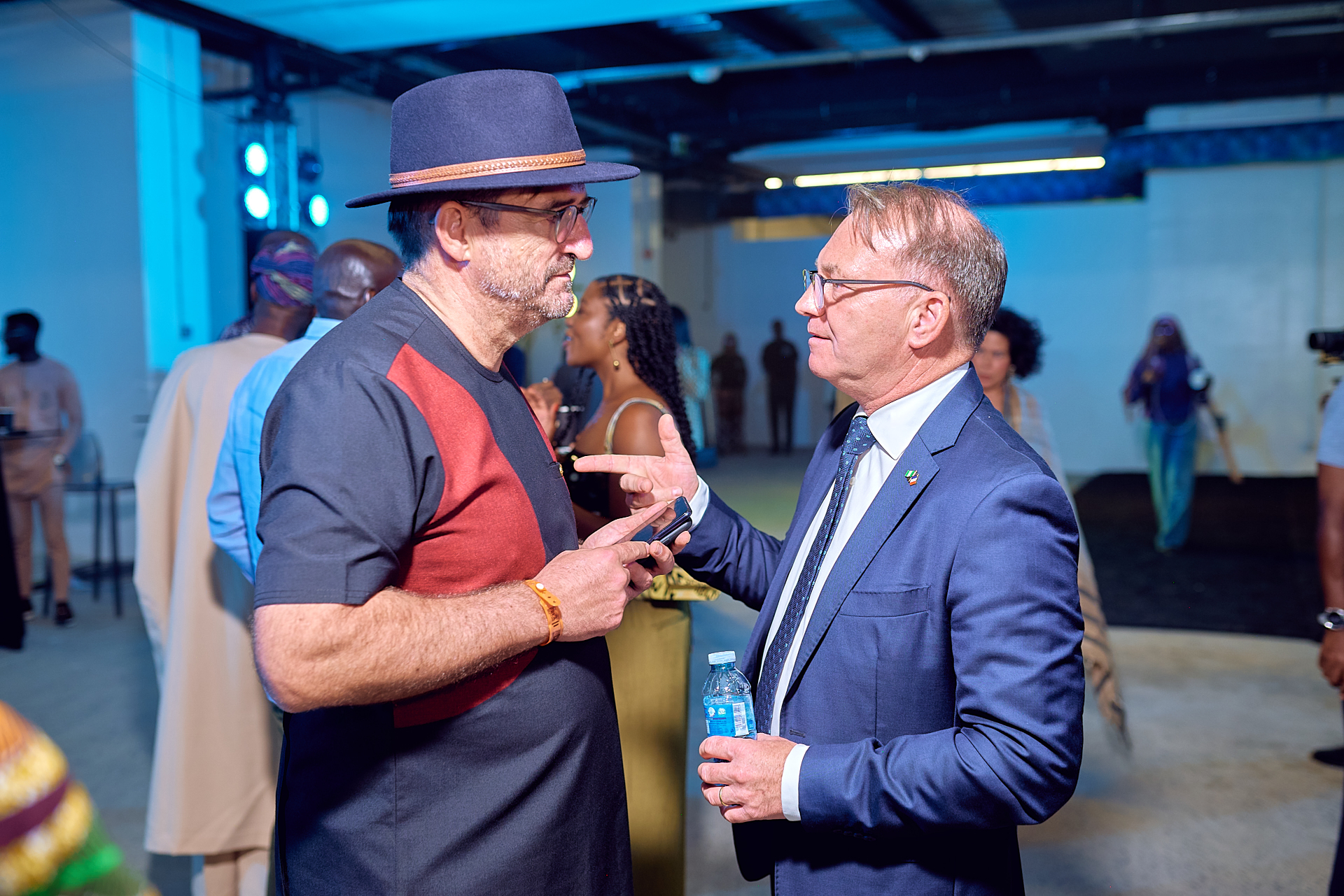 Two guests in conversation at the Afrobeat Rebellion opening reception