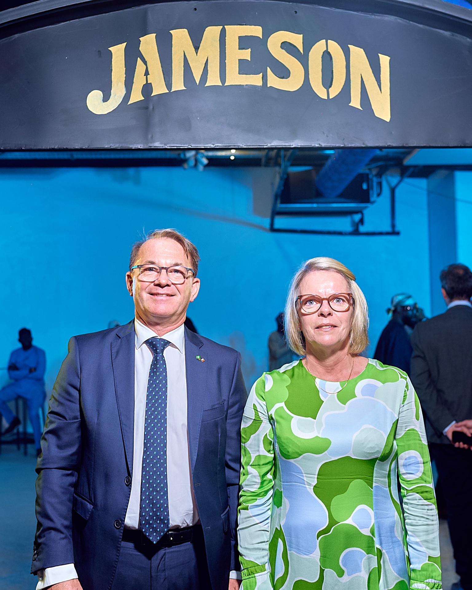 Guests posing beneath the Jameson signage inside the Afrobeat Rebellion venue