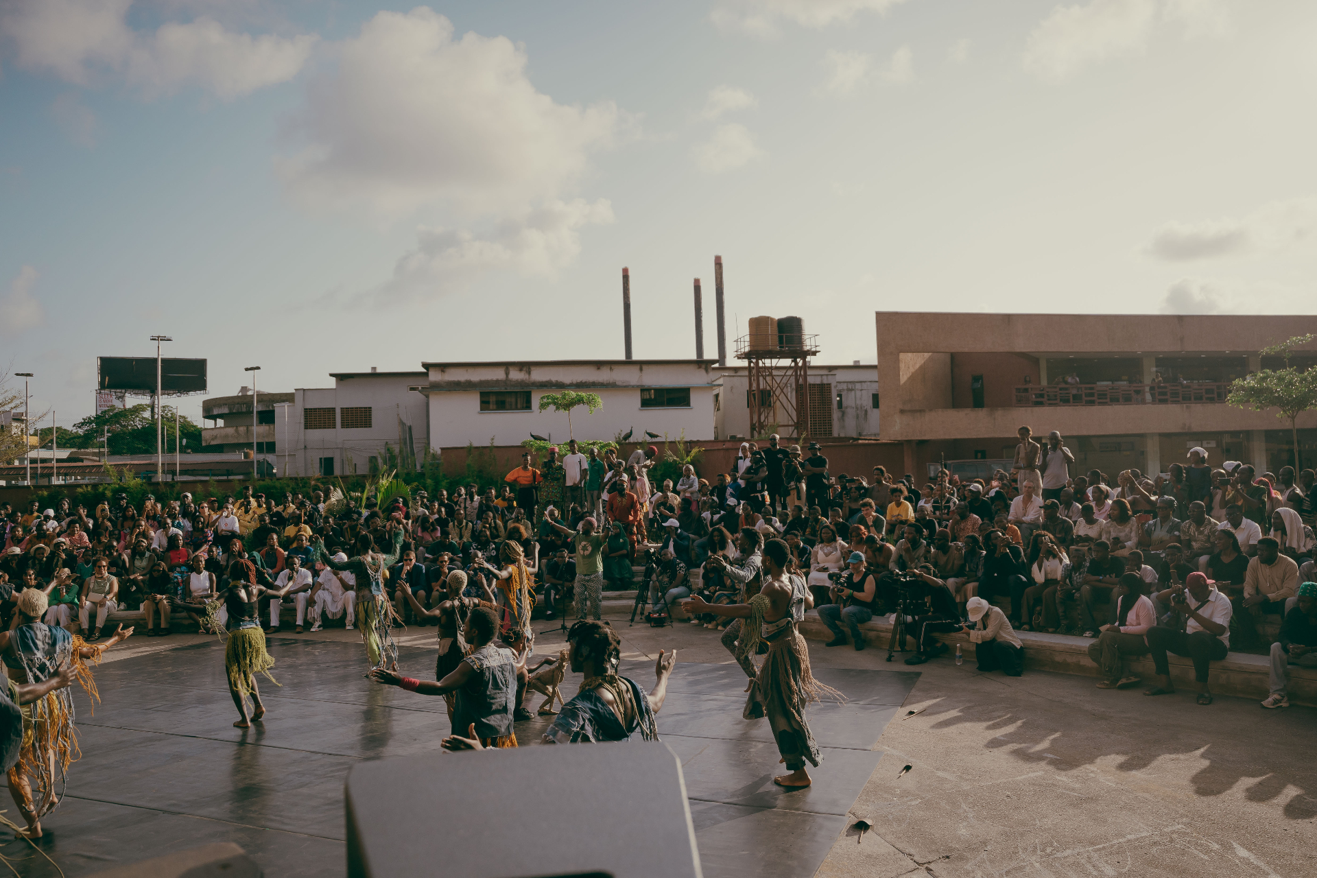 Dancers performing to a crowd at an outdoor Lagos venue